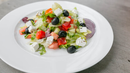 Greek Caesar, greens, feta, olives, cucumbers, tomatoes