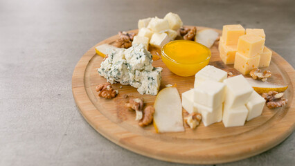cheese plate, cheese cubes on a wooden tray