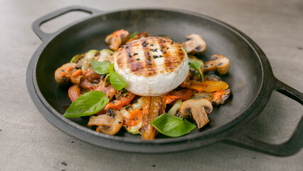 menu photo,  Camembert with grilled vegetables in a black plate