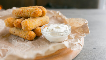 Breaded cheese sticks with sauce