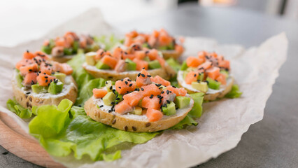 bruschetta sandwiches with salmon and avocado on a baguette, a snack before dinner,