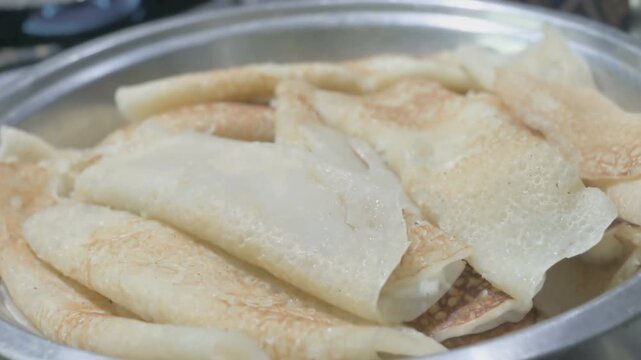 Patishapta Pitha, a famous Bengali Dessert Recipe, being prepared during Winter season. Patishapta is a type of pithe made in celebratory occasions, quick Indian dessert. Howrah, West Bengal, India