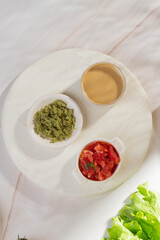 Vegetable sauces of different colors in bowls on a light background