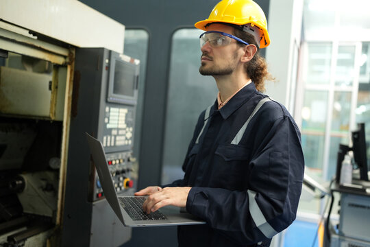 Engineer check and control welding robotics automatic arms machine in intelligent factory automotive industrial with monitoring system software. Digital manufacturing operation.