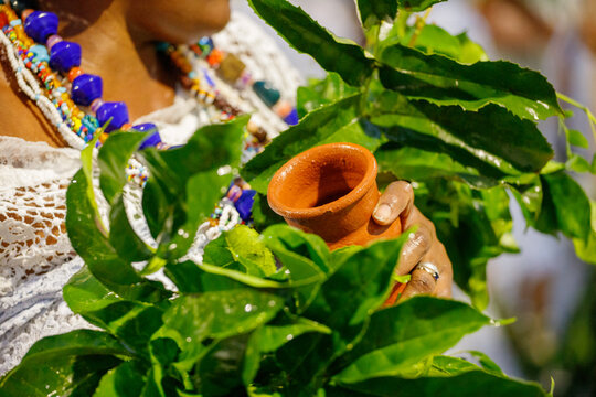 clay vase in a woman's hand during an iemanja party in Rio de Janeiro.