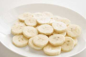 Banana slices on a white plate. Healthy and dietary food. 