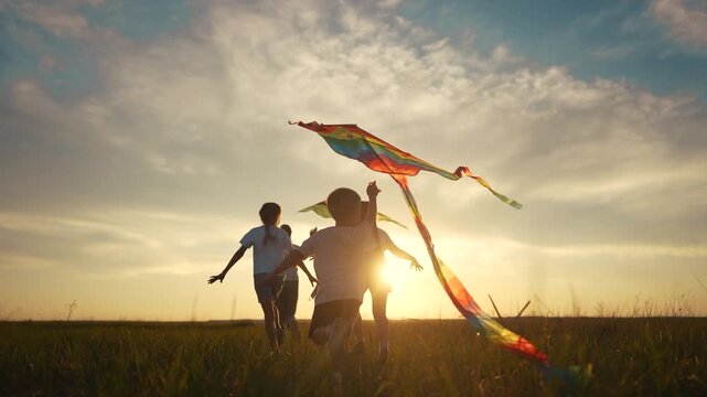A family of children are running around in a kite. Child run kid concept. A group of children are running on a kite. A group of children and their families are running lifestyle on a kite.