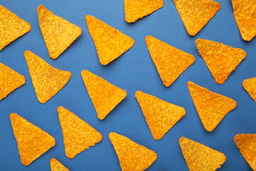 Corn chips nachos on blue background, top view