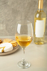 Wine tasting. Parmesan cheese with glass of wine on light background. Cheese plate. Wine card, restaurant menu.