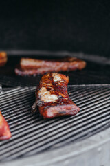 Mouthwatering Rack of Ribs on Round Grill. Glazed Barbecue Meat Over Hot Coals