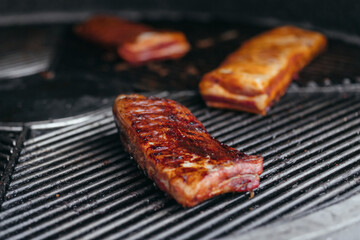 Mouthwatering Rack of Ribs on Round Grill. Glazed Barbecue Meat Over Hot Coals