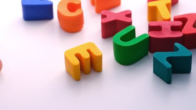 A man with dyslexia trying to spell a word with letters. Close up.