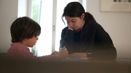 Parent and child deeply focused on a learning activity at home, showcasing dedication to education and the importance of parental involvement in a cozy indoor setting