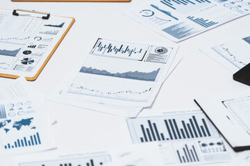 Piles of business intelligence paper or BI financial report and financial data visualization on paperwork for business analytic marketing and strategic planning at office desk. Prudent