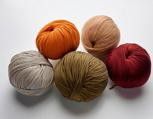 Balls of woolen yarn for knitting on a white background.