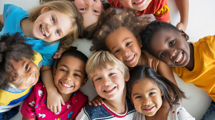 A group of children are smiling and hugging each other in a circle