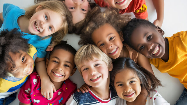 A group of children are smiling and hugging each other in a circle