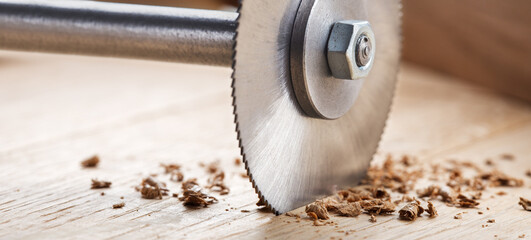 Circular saw cutting wooden plank. Circular milling in oak block.