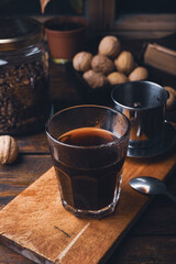 Glass of coffee brewed in traditional vietnamese drip filter