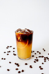 A mix of bright orange and rich coffee with ice, garnished with coffee beans for a refreshing twist to enjoy