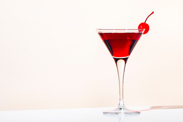 Black Manhattan cocktail with whiskey and red vermouth garnished with maraschino cocktail cherry in...