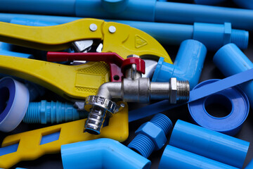Plumber equipment with blue pvc pipe connections for plumbing work.