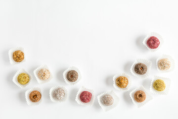 Box of healthy sweets, candies made from natural ingredients. Vegetarian organic food. White background, top view, copy space