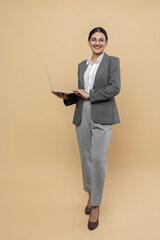 Attractive happy woman in formal wear using laptop for remote work