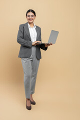 Smiling woman in formal wear using laptop for office work