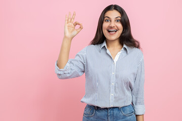 Amazed Indian woman showing okay gesture advertisement