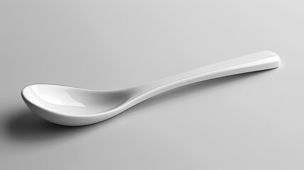 White ceramic spoon lying on a white background