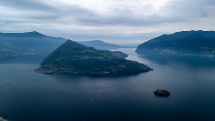 Misty Mountainous Landscape Overlooking Serene Lake in Early Morning Light