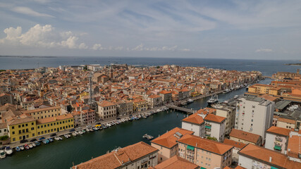 Fototapeta premium Panoramic View of Colorful Buildings and Boats Along the Canal in Coastal City