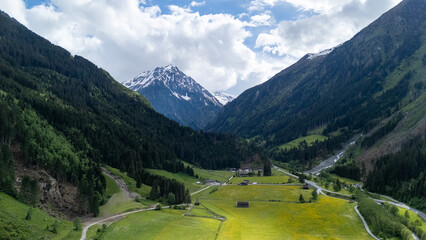Breathtaking Mountain Landscape With Lush Green Valleys and Snow-Capped Peaks Under a Clear Blue Sky