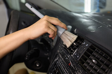 Car Interior Cleaning process underway with a brush for detailed professional detailing