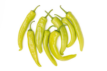 A bunch of green hot chili peppers on a white background