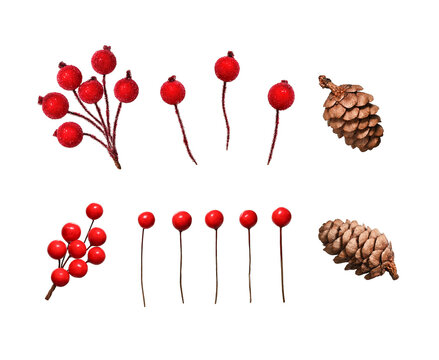 A set for decorating Christmas arrangements. Artificial decorative red berries and natural cones isolated on a white background.