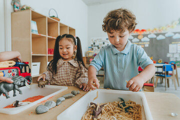 Children playing with toy figures in bulk cereals and pasta in kindergarten