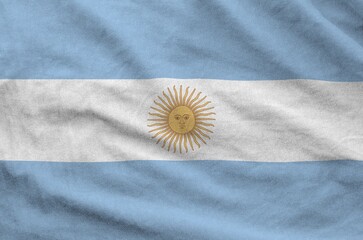 Argentina flag depicted on folded wavy fabric of old cloth close up