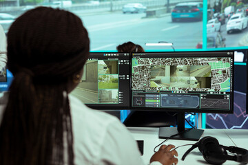 Agency employee following city traffic on her computer by using CTV video footage, ensuring public...