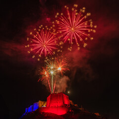 Fireworks in the night sky in Bonifacio in Corsica on the national holiday with a view of the citadel