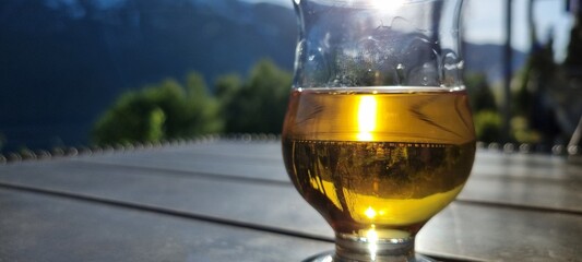 glass of whiskey in the afternoon sunshine on patio close up