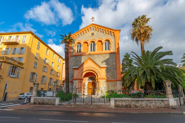 The Reformed Protestant Church of France surrounded by palm trees in the Mediterranean city of Menton, France.	