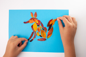 Fox made of leaf on blue background, autumn craft for kid, animal clip art collage made of dry dead...