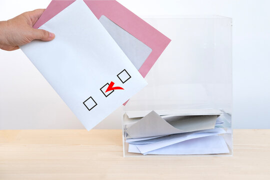 female hand voter with election ballot paper in transparent ballot box, list choosing political parties, voting rights, civic duty, citizen participation