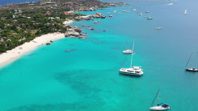 Flying in Reverse and Tilting Up Revealing Anchored Catamarans at Virgin Gorda Island - BVI
