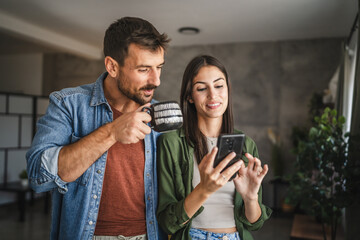 Portrait of girlfriend show mobile phone screen to her boyfriend
