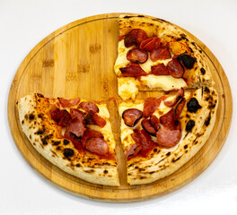 Rustic artisanal pizza with calabrese sausage and pepperoni, isolated on white background