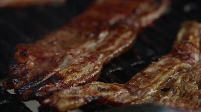 During the sunset, Kalbi meat sizzled on the gas grill in the front yard, the marinated beef caramelizing to perfection, its aroma mingling with the evening breeze, creating a mouthwatering scene.