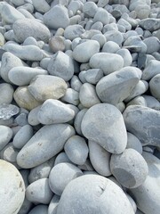 white  and grey sea round british stones | texture background